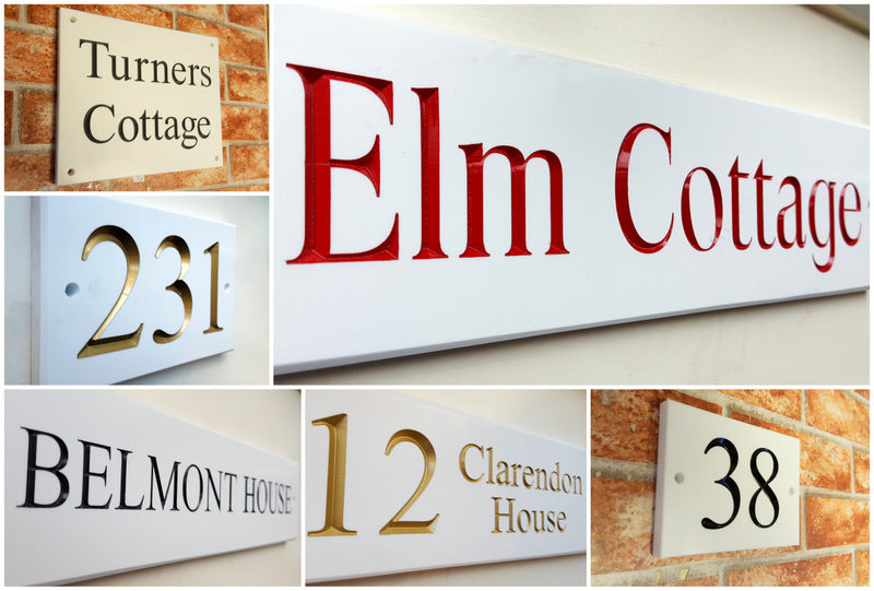White house sign with black engraved numbers in solid surface material