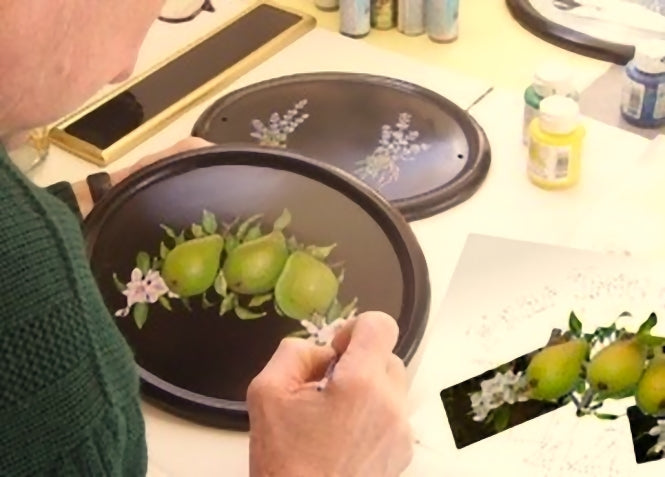 Artist hand paiting a house sign